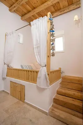 a room with a bunk bed and a staircase at White Rose in Kalithies