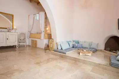 a living room with a couch and a table at White Rose in Kalithies