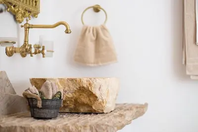 a bathroom with a stone counter with a towel at White Rose in Kalithies