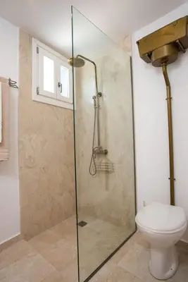 a shower stall with a toilet in a bathroom at White Rose in Kalithies