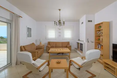 a living room with a couch and chairs and a table at Villa Evelyn in Pefki Rhodes