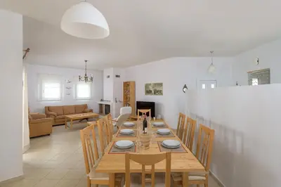 a dining room with a wooden table and chairs at Villa Evelyn in Pefki Rhodes