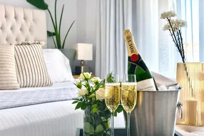 a room with two glasses of champagne and a bucket of flowers at Villa Almihauss - Adults Only in Afantou