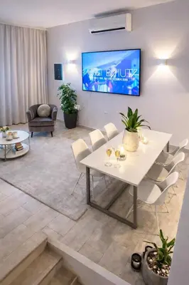 a living room with a white table and chairs at Villa Almihauss - Adults Only in Afantou