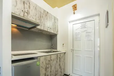 a kitchen with a sink and a white door at Lisabeth Apartments in Faliraki