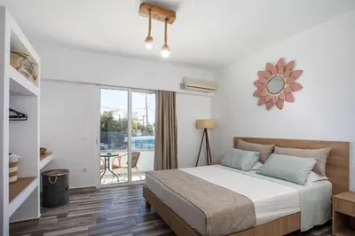 a bedroom with a bed and a balcony at Lisabeth Apartments in Faliraki
