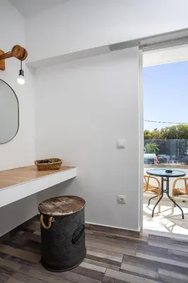 a kitchen with a table and a trash can at Lisabeth Apartments in Faliraki
