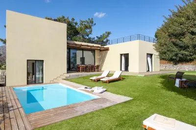 a backyard with a swimming pool and a house at South Key Villa in Pefki Rhodes