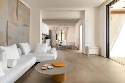 a living room with a white couch and a table at South Key Villa in Pefki Rhodes
