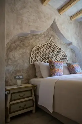a bedroom with a king sized bed and a side table at DECAN Concept Boutique Estate in Rhodes Town