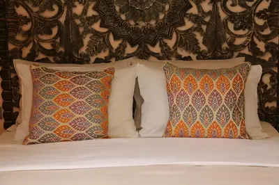 a bed with two pillows and a wall at DECAN Concept Boutique Estate in Rhodes Town