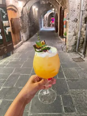 a person holding up a mimosa in a glass at DECAN Concept Boutique Estate in Rhodes Town
