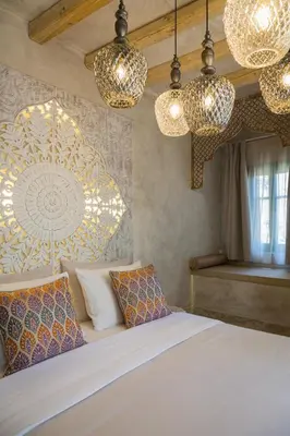 a bedroom with chandeliers and a bed with pillows at DECAN Concept Boutique Estate in Rhodes Town
