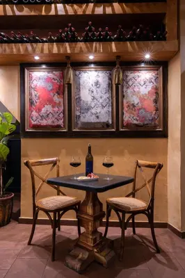 a table with two chairs and two windows with wine glasses at DECAN Concept Boutique Estate in Rhodes Town