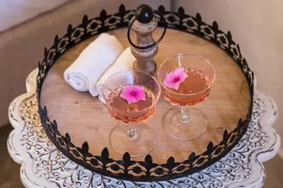 two wine glasses sitting on a wooden table at DECAN Concept Boutique Estate in Rhodes Town