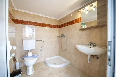 a bathroom with a toilet and a sink at Springs Petronas Apartment in Archangelos
