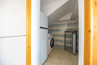 a laundry room with a washer and dryer at Springs Petronas Apartment in Archangelos