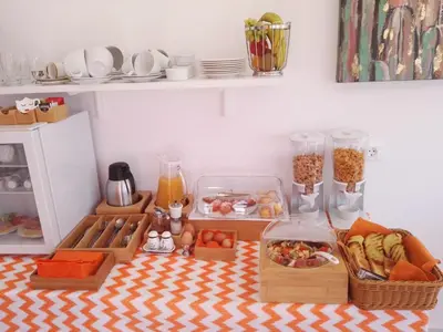a table with food and other items in a kitchen at Bouganville Bed & Breakfast Stegna in Archangelos
