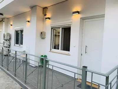 a walkway with a white wall and a door at Apartment Marla in Rhodes Town