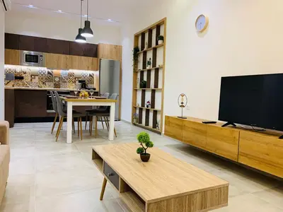 a living room with a flat screen tv and a table at Apartment Marla in Rhodes Town