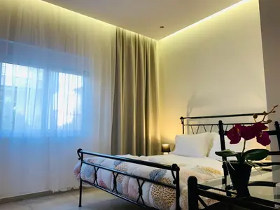 a bedroom with a bed with a glass table and a window at Apartment Marla in Rhodes Town