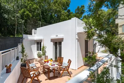 a patio with a table and chairs on a balcony at Oasis in the Heart of Rhodes, next to Old Town, near Beaches - Haven Home in Rhodes Town