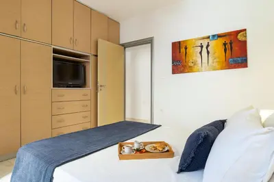 a bedroom with a bed with a tray of teddy bears on it at Oasis in the Heart of Rhodes, next to Old Town, near Beaches - Haven Home in Rhodes Town