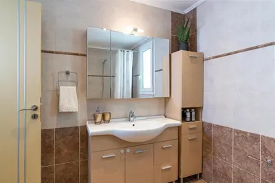 a bathroom with a sink and a mirror at Oasis in the Heart of Rhodes, next to Old Town, near Beaches - Haven Home in Rhodes Town