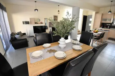 a dining room and living room with a table and chairs at Dionysus seaside villa in Ialyssos