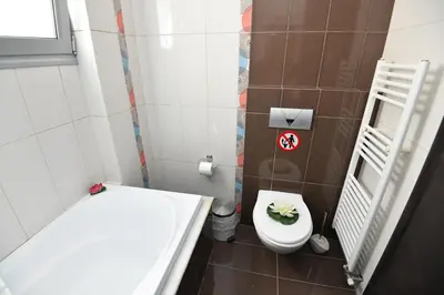 a small bathroom with a toilet and a sink at Dionysus seaside villa in Ialyssos