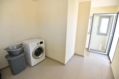 a laundry room with a washing machine and a window at Dionysus seaside villa in Ialyssos