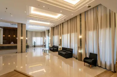 a lobby with couches and chairs in a building at Castellum Suites - All Inclusive in Rhodes Town