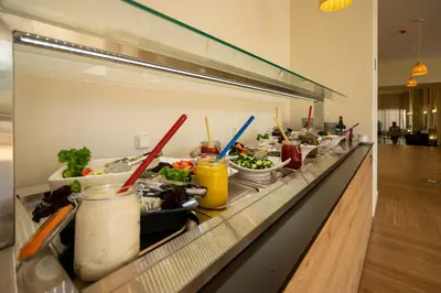 a buffet line with many different types of food at Castellum Suites - All Inclusive in Rhodes Town