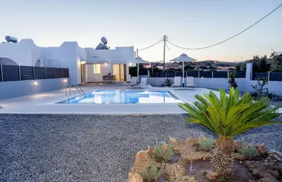 a house with a swimming pool in a yard at Aegean Horizon apartments in Gennadi