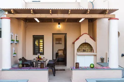 a house with a patio with a table and a kitchen at Kolymbia memories house in Kolimbia