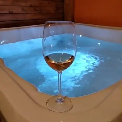 a glass of wine sitting in a bath tub at Casa de Mikel in Rhodes Town