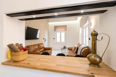 a living room with a table and a couch at Alia Apartments in Rhodes Town