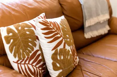 two pillows sitting on top of a couch at Alia Apartments in Rhodes Town