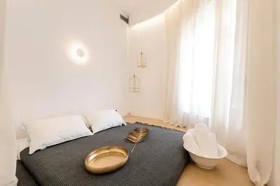 a bedroom with a bed with a gold bowl on it at Alia Apartments in Rhodes Town