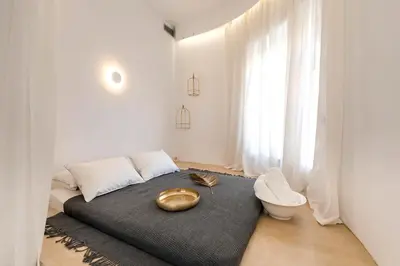 a bedroom with a large bed with a large window at Alia Apartments in Rhodes Town
