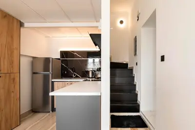 a kitchen with a counter and a staircase in a room at Alia Apartments in Rhodes Town