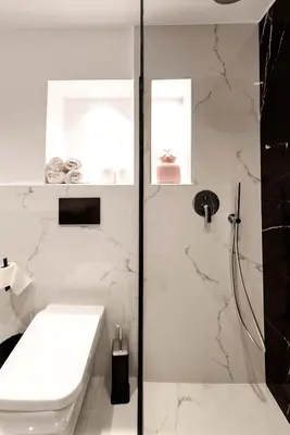 a white bathroom with a shower and a sink at Alia Apartments in Rhodes Town