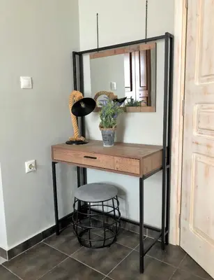 a dressing table with a mirror and a stool at Stone House Halki in Halki