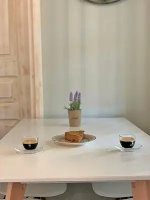 two cups of coffee and a plate of bread on a table at Stone House Halki in Halki