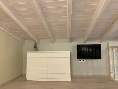a living room with a flat screen tv on a ceiling at Stone House Halki in Halki