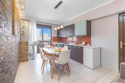 a kitchen and dining room with a table and chairs at 3- Sea view luxury suite in the center of Rhodes! in Rhodes Town