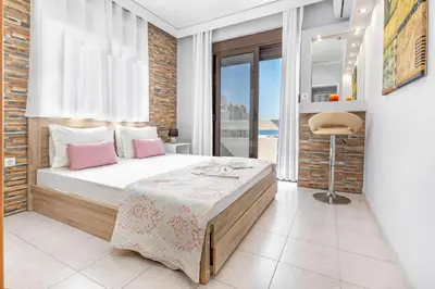 a bedroom with a bed with pink pillows at 3- Sea view luxury suite in the center of Rhodes! in Rhodes Town