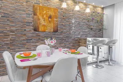 a dining room with a white table and white chairs at 3- Sea view luxury suite in the center of Rhodes! in Rhodes Town