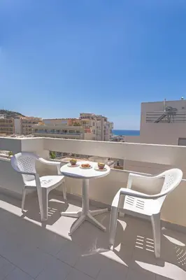 a patio with a table and chairs on a roof at 3- Sea view luxury suite in the center of Rhodes! in Rhodes Town