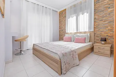 a bedroom with a bed and a brick wall at 3- Sea view luxury suite in the center of Rhodes! in Rhodes Town
